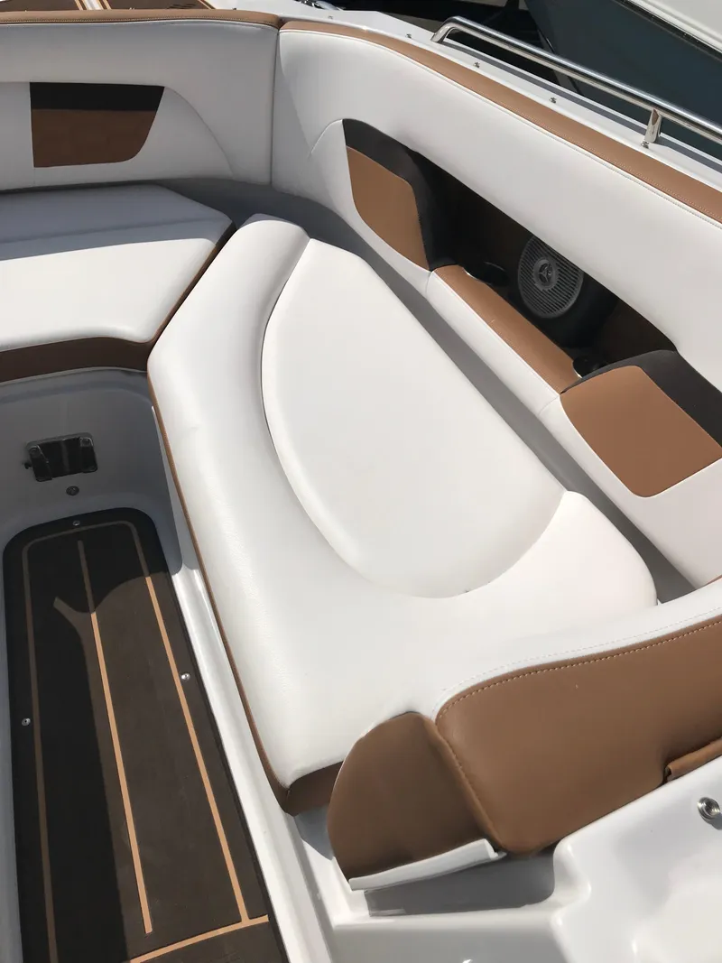 Slide: The Image of Interior of a 2019 Four Winns HD270 boat with white and brown upholstery. - 18
