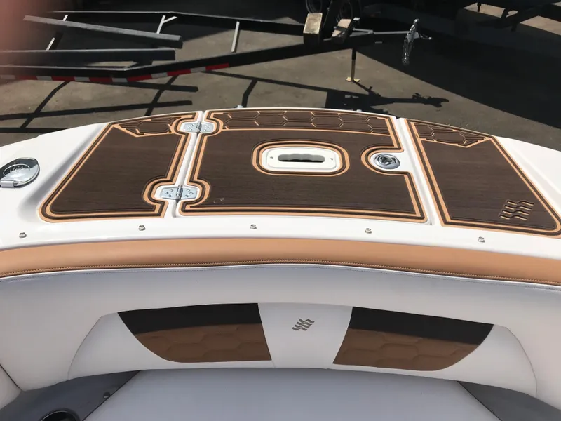 Slide: The Image of 2019 Four Winns HD270 boat deck with brown and white upholstery. - 24