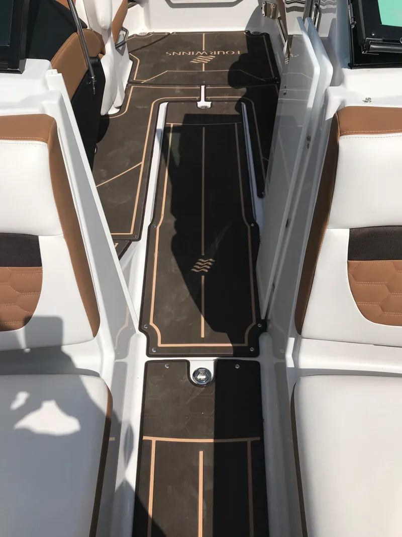 Slide: The Image of Interior of a 2019 Four Winns HD270 boat with brown and white seating. - 26