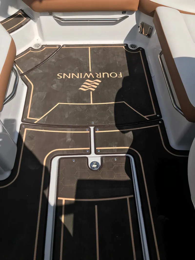 Slide: The Image of Interior of a 2019 Four Winns HD270 boat with branded flooring. - 32