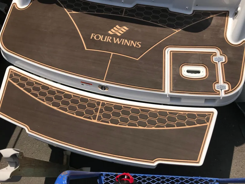 Slide: The Image of 2019 Four Winns HD270 boat stern platform with wood finish. - 38