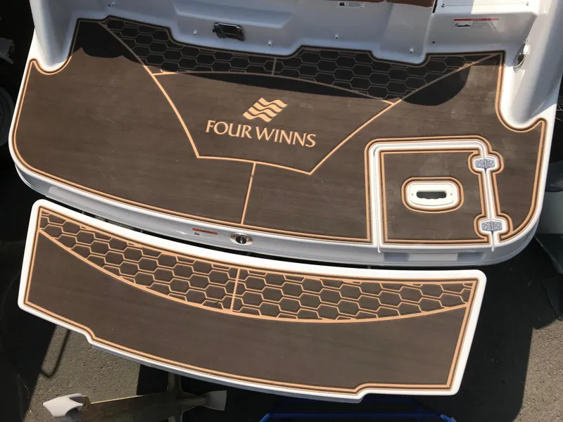 Slide: The Image of Rear deck of 2019 Four Winns HD270 boat with wood finish. - 39