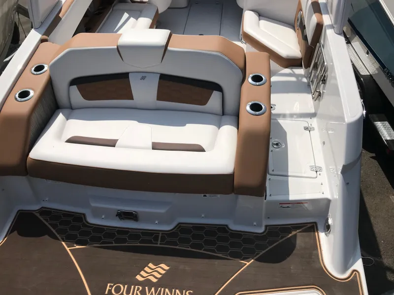 Slide: The Image of Interior of a 2019 Four Winns HD270 boat with brown and white seating. - 40