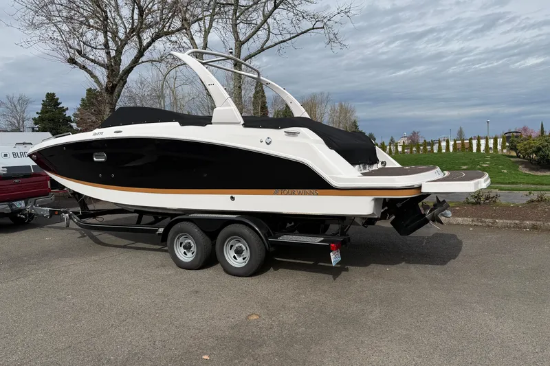 Slide: The Image of 2019 Four Winns HD270 boat on trailer, parked outdoors on a cloudy day. - 44