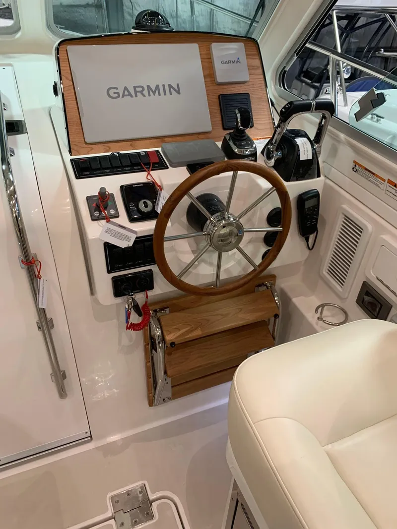 Slide: The Image of 2027 Back Cove 34O Hardtop Express helm with Garmin navigation system and wooden steering wheel. - 6