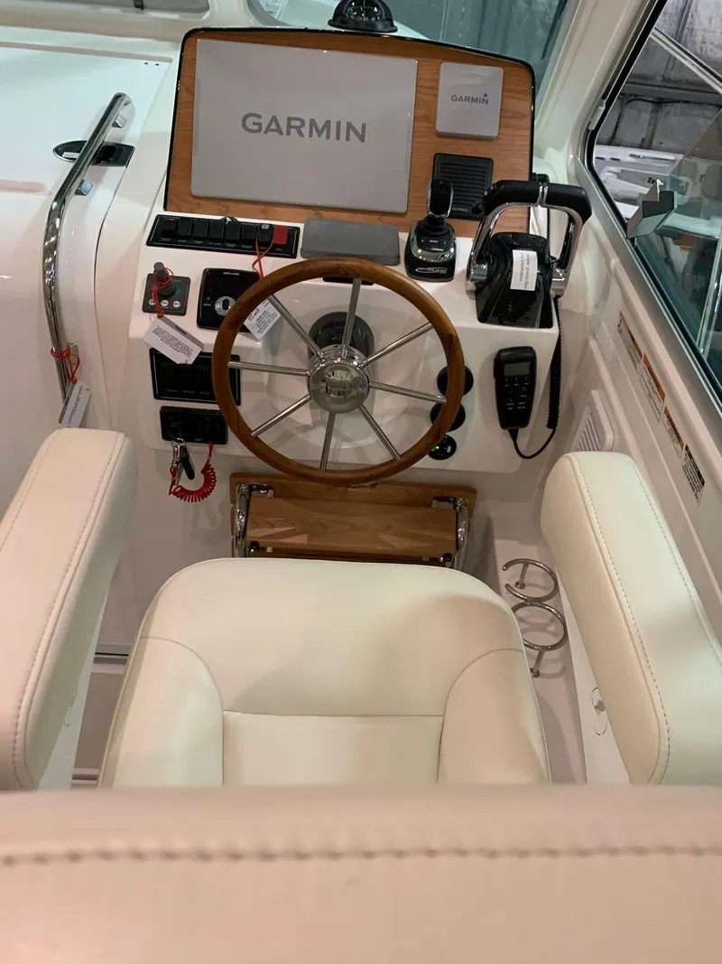 Slide: The Image of 2027 Back Cove 34O Hardtop Express helm with Garmin navigation system and luxurious seating. - 7