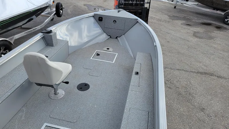 Slide: The Image of 2023 Smoker Craft Freedom 16 tiller boat interior with seating and storage compartments. - 13