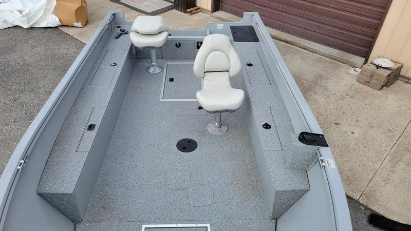 Slide: The Image of 2023 Smoker Craft Freedom 16 boat interior with two swivel seats and storage compartments. - 15