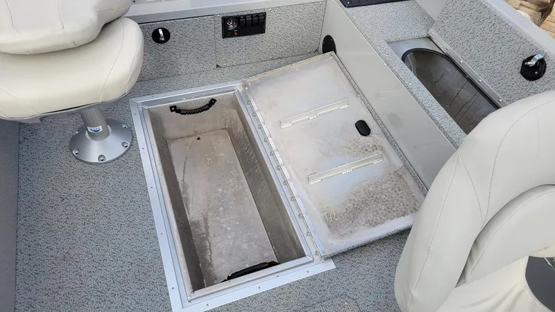 Slide: The Image of 2023 Smoker Craft Freedom 16 interior with storage compartment and seating. - 17