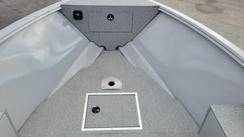 Slide: The Image of 2023 Smoker Craft Freedom 16 boat interior, featuring a deep V hull design and storage compartments. - 6