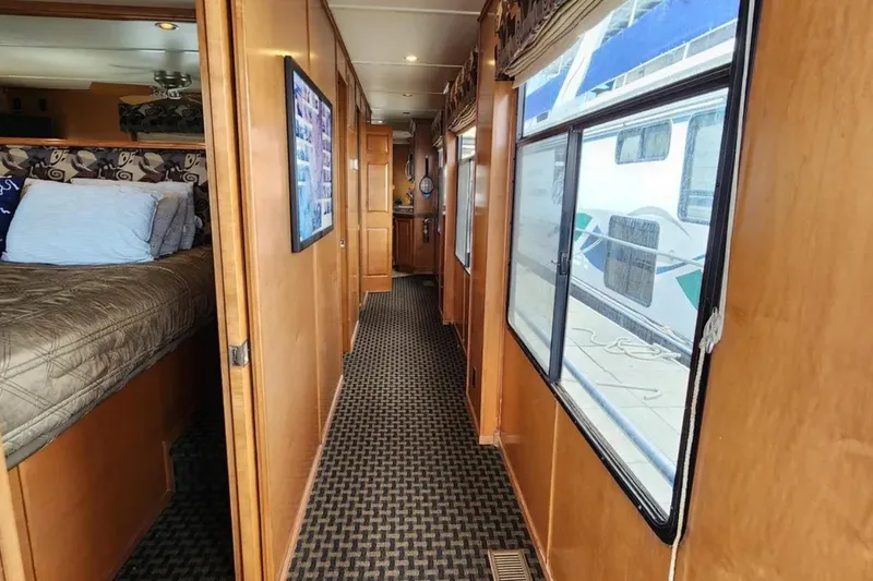 Slide: The Image of Interior of 2008 Sumerset Blue Moon Trip #11 houseboat, featuring cozy bedroom and hallway. - 10