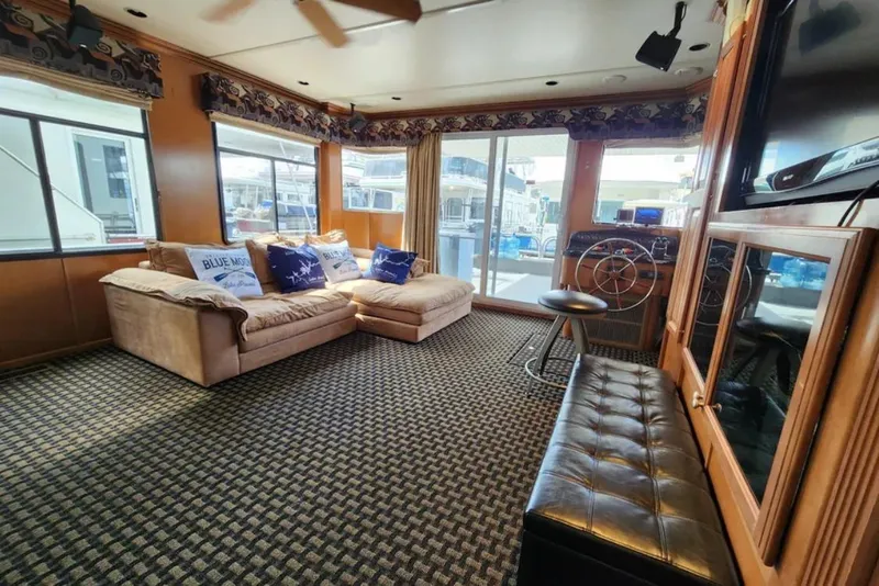 Slide: The Image of Luxurious Sumerset houseboat interior with plush seating, nautical decor, and large windows, 2008 model. - 12