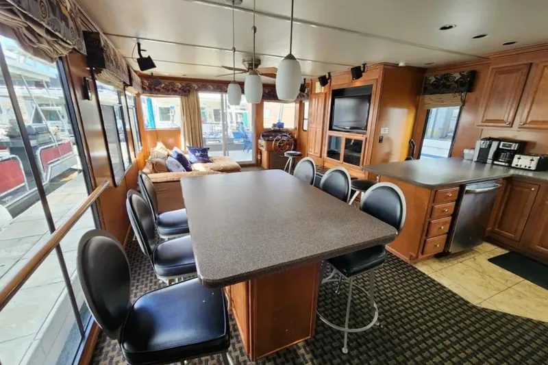 Slide: The Image of Luxurious 2008 Sumerset Blue Moon houseboat interior with dining area and modern kitchen amenities. - 15