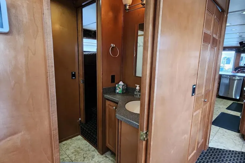 Slide: The Image of Interior of 2008 Sumerset Blue Moon Trip #11, featuring a compact bathroom with wooden cabinetry. - 16