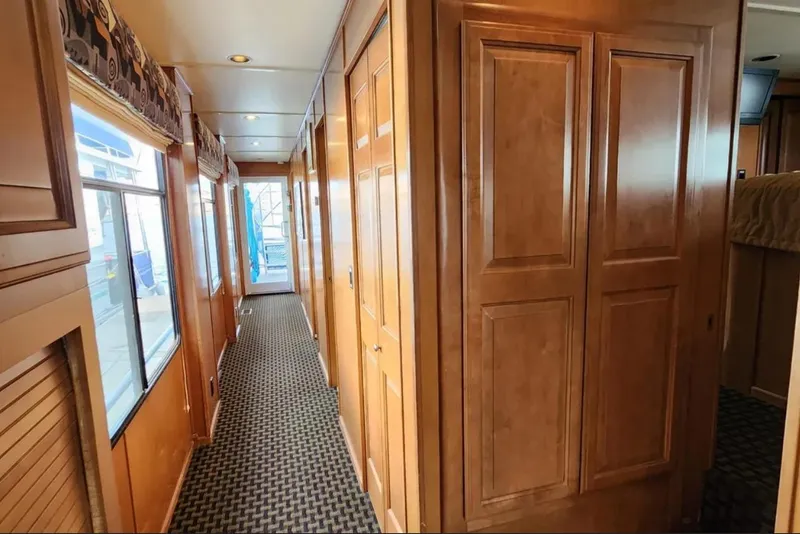 Slide: The Image of Interior hallway of 2008 Sumerset Blue Moon Trip #11 houseboat, featuring wood paneling and carpet. - 19