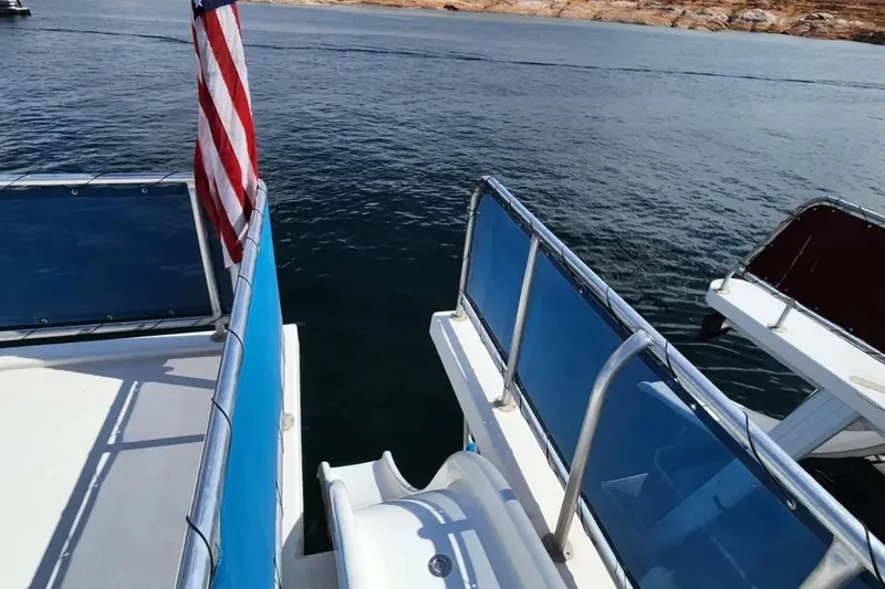 Slide: The Image of Houseboat deck with American flag, Sumerset Blue Moon Trip, 2008, on calm water. - 24