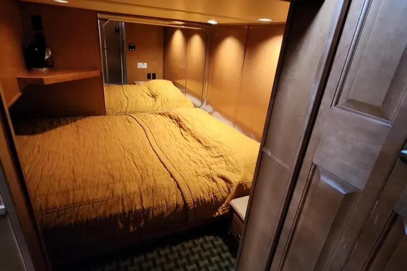 Slide: The Image of Cozy bedroom in 2008 Sumerset Blue Moon Trip #11 houseboat with warm lighting and wood accents. - 6