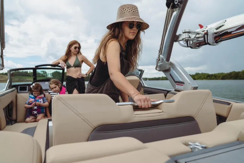 Slide: The Image of 2023 MasterCraft XStar boat with family enjoying a day on the water. - 13