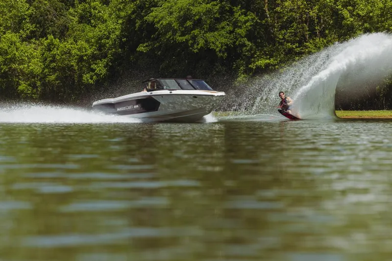 Slide: The Image of 2023 MasterCraft ProStar towing a water skier on a lake. - 10