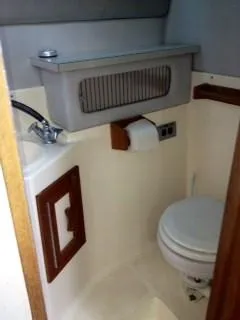 Slide: The Image of 1988 Baha Cruisers 260 Express Cruiser bathroom with sink and toilet. - 3