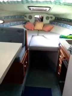 Slide: The Image of Interior cabin of a 1988 Baha Cruisers 260 Express Cruiser with seating and bedding. - 4
