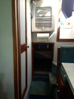 Slide: The Image of Interior of 1988 Baha Cruisers 260 Express Cruiser, featuring cabin steps and storage. - 5