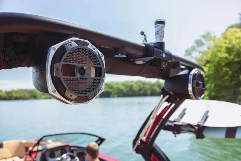 Slide: The Image of 2023 MasterCraft X24 boat with wakeboard tower speakers on a lake. - 10