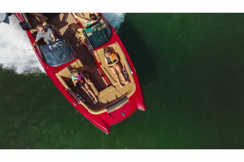 Slide: The Image of Aerial view of 2023 MasterCraft X24 boat cruising on water. - 13