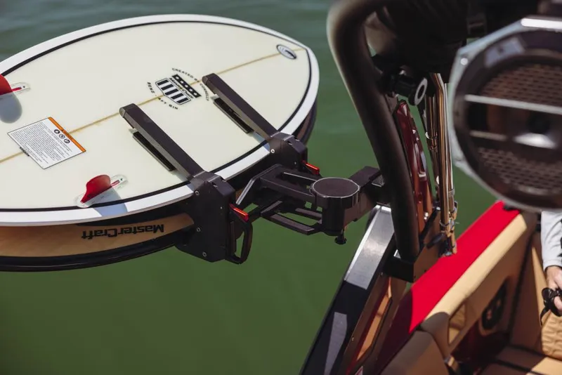 Slide: The Image of 2023 MasterCraft X24 boat with mounted surfboard holder. - 25