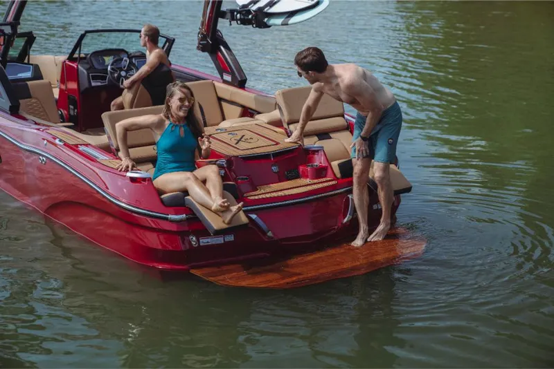 Slide: The Image of 2023 MasterCraft X24 boat with people enjoying water activities. - 4