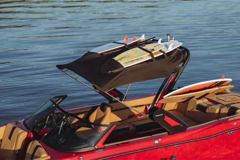 Slide: The Image of 2023 MasterCraft X24 boat with surfboards on the water. - 5