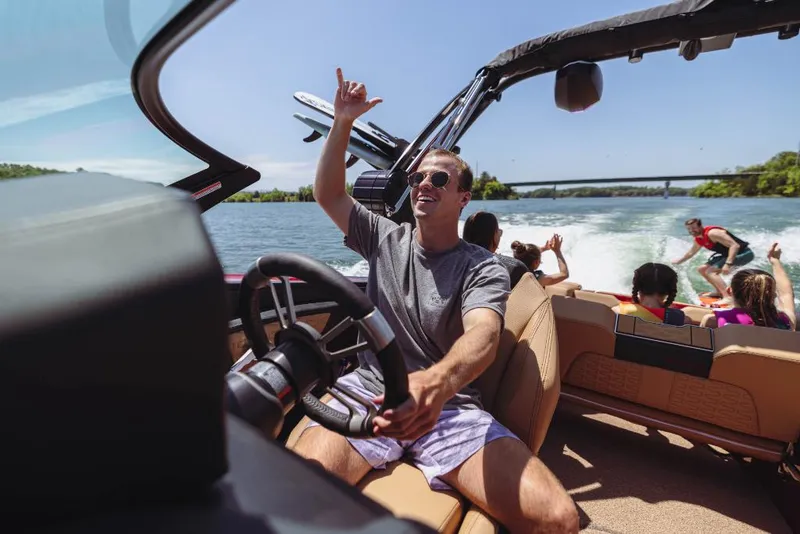 Slide: The Image of 2023 MasterCraft X24 boat with people enjoying water sports. - 6