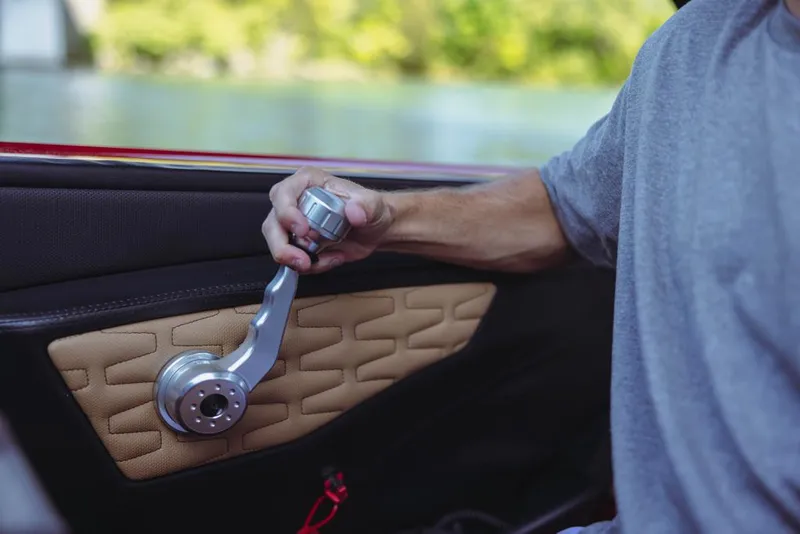 Slide: The Image of Close-up of a person operating the throttle of a 2023 MasterCraft X24 boat. - 9