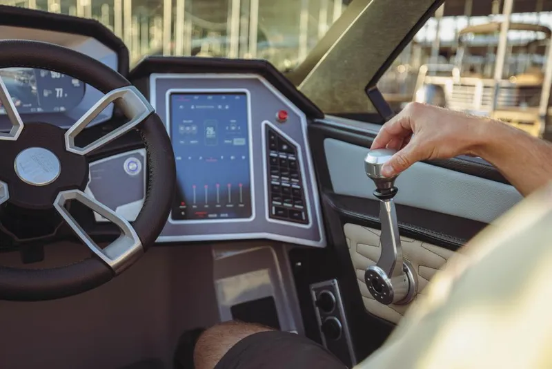 Slide: The Image of 2023 MasterCraft X26 boat dashboard with touchscreen and control lever. - 12