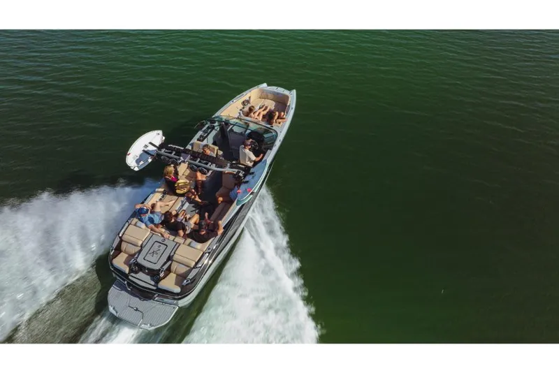 Slide: The Image of 2023 MasterCraft X26 boat cruising on a lake with passengers. - 14