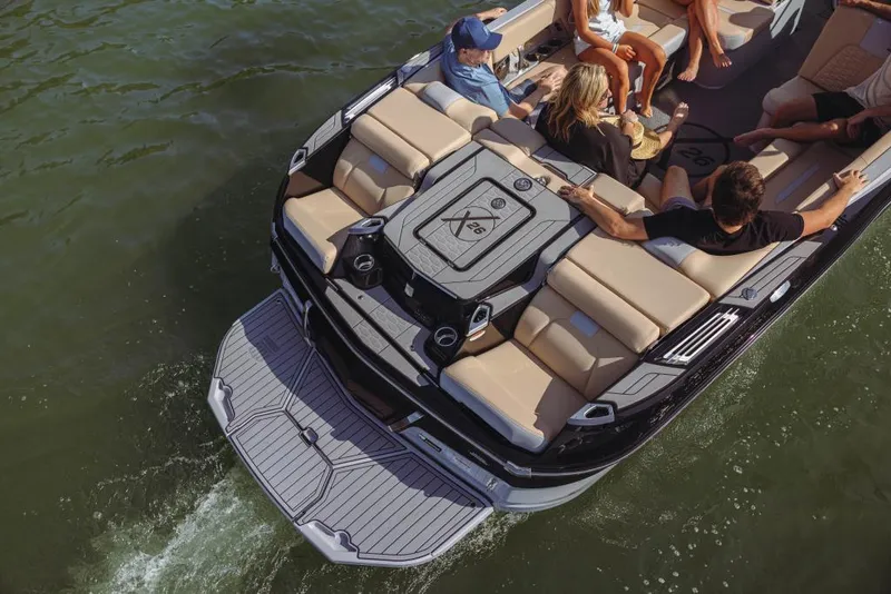 Slide: The Image of 2023 MasterCraft X26 boat with passengers enjoying a ride on the water. - 3