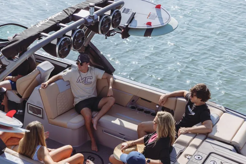 Slide: The Image of 2023 MasterCraft X26 boat with people relaxing on deck in sunny weather. - 4