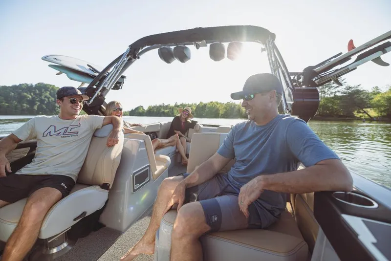 Slide: The Image of 2023 MasterCraft X26 boat with people enjoying a sunny day on the water. - 7