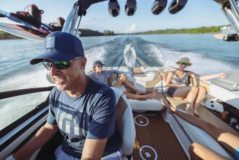 Slide: The Image of 2023 MasterCraft XT20 boat with people enjoying a sunny day on the water. - 12