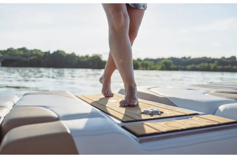 Slide: The Image of Person standing on the deck of a 2023 MasterCraft XT20 boat. - 14
