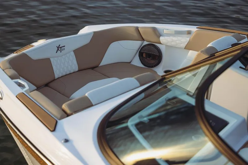 Slide: The Image of 2023 MasterCraft XT20 boat interior with luxurious seating and premium audio system. - 17