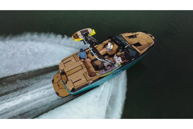 Slide: The Image of 2023 MasterCraft XT22 boat cruising on water, aerial view. - 13