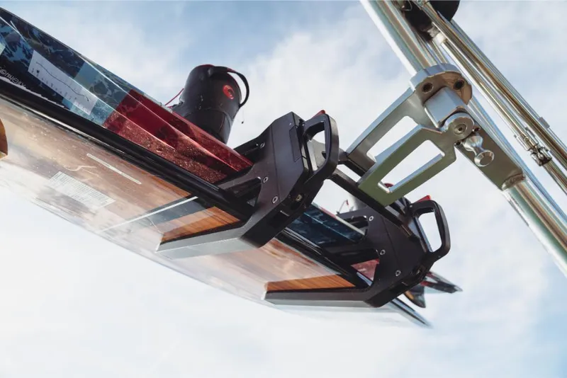 Slide: The Image of 2023 MasterCraft XT22 wakeboard rack against blue sky. - 8