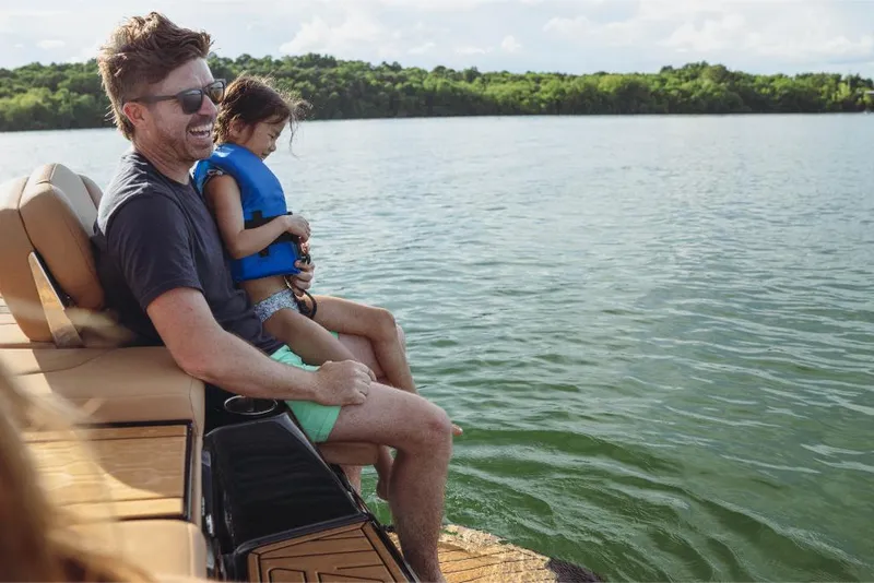 Slide: The Image of Father and daughter enjoying a day on a 2023 MasterCraft XT22 boat. - 9