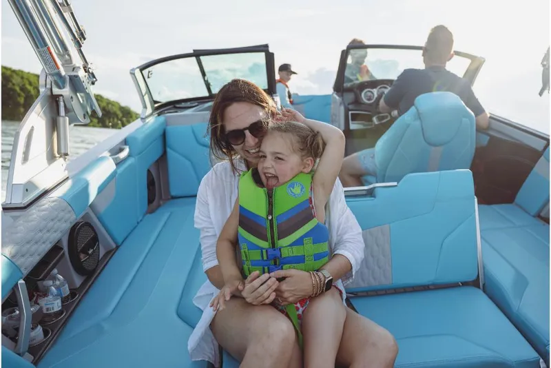 Slide: The Image of Family enjoying a day on a 2023 MasterCraft XT23 boat. - 13