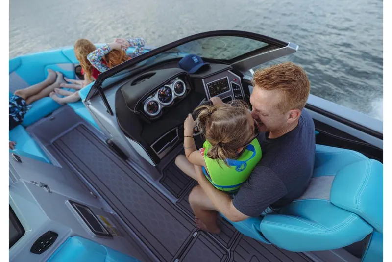 Slide: The Image of Family enjoying a ride on a 2023 MasterCraft XT23 boat. - 17