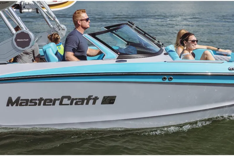 Slide: The Image of 2023 MasterCraft XT23 boat cruising on the water with passengers. - 4