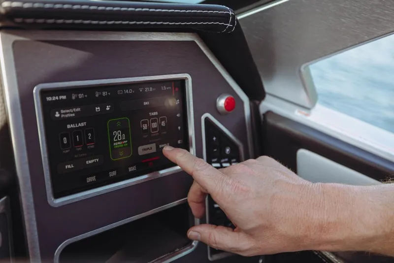 Slide: The Image of Hand operating touchscreen control panel on 2023 MasterCraft XT23 boat. - 9