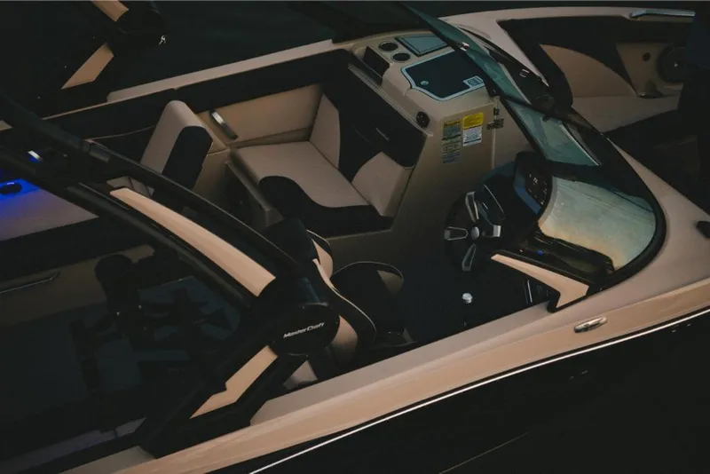 Slide: The Image of 2022 MasterCraft XT25 boat interior with modern dashboard and seating. - 14