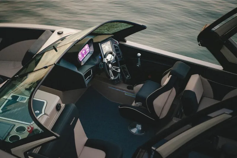 Slide: The Image of 2022 MasterCraft XT25 boat interior with modern dashboard and seating. - 16